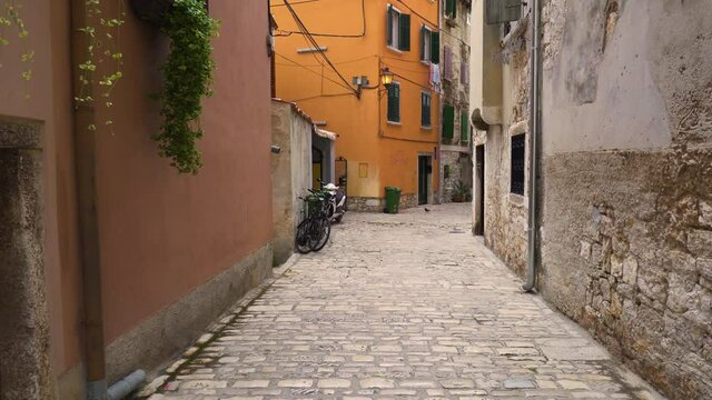 Croatia. The city of Rovinj on the coast of the Adriatic Sea. Narrow street of the old city. Panorama. The camera moves from right to left