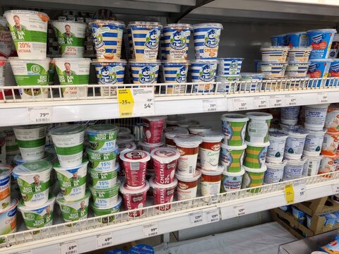 Packages with sour cream for sale on supermarket shelves
