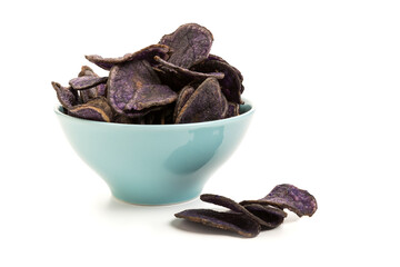 Potato chips made from purple potatoes in a bowl isolated on white background