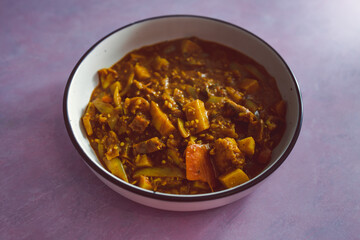 vegan thai red curry with potatos and mixed vegetables, healthy plant-based food
