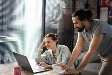 Young people hipster man woman working in office on project using laptop