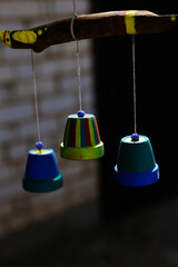 colorful wooden bell toys hanging on strings
