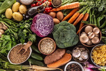 Choice of fresh food and healthy eating: vegetables, fruits, legumes and cereals on a concrete table.