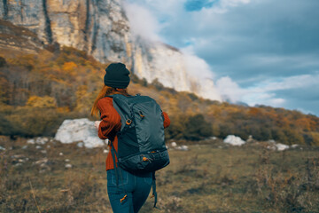 Obraz na płótnie Canvas travel tourism woman with backpack high mountains sky landscape