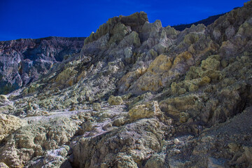 Steep volcano crater walls and the dangerous road, where many travelers hiked, climbing up to the...