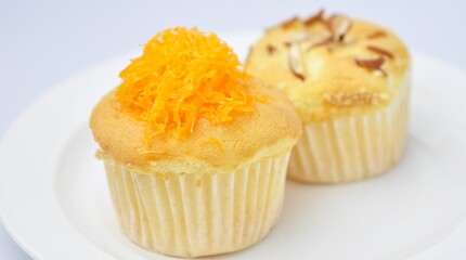 Delicious golden foi cupcakes on white background