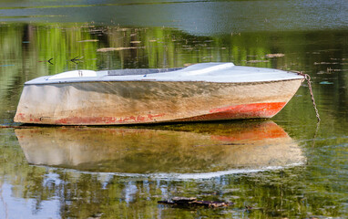 A moored fishing boat in the water on the bank of the Danube tributary near Novi Sad. 