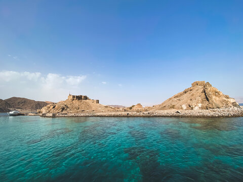 Mobile photo of Pharaoh island, Egypt. Seascape with ancient Castle of Saladin on the Farun Island in the Gulf of Aqaba. Old fortress of Sultan Salah El Din in Taba, travel on Sinai Peninsula.