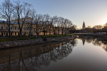 Fototapeta premium Scenic view of calm Aura river at sunrise with the Cathedral in the background in Turku, Finland.