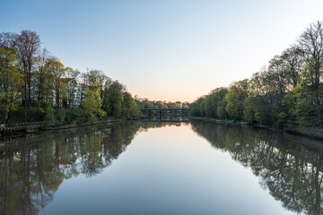 Fototapeta na wymiar Calm river at dawn in springtime