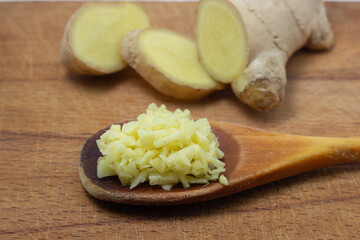 Ginger on a wooden background. Chopped ginger root. Healthy food. Healthy food concept
