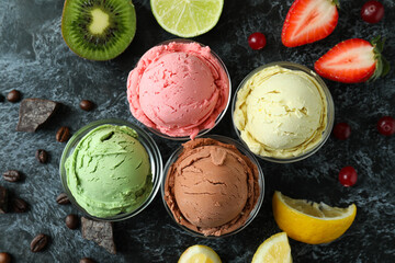 Fruit ice cream and ingredients on black smokey background
