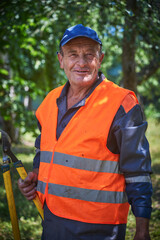 Portrait of smiling old man wearing safety vest