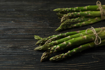 Bunches of green asparagus on wooden background