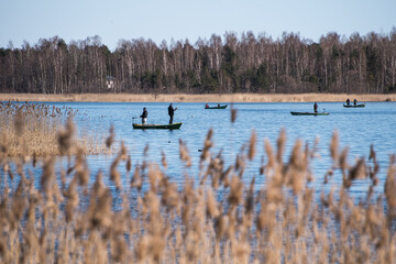 Fishermans with boats in the Kanieris lake, Latvia