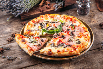Appetizing fresh pizza with mushrooms and tomato on the wooden background