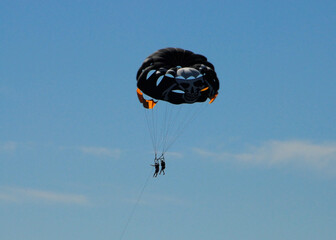 Two persons paragliding in the blue sky. Cagnes sur Mer, France.