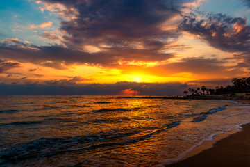 Sunset over ocean. Dramatic sky.