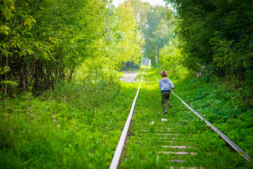 boy walking on old railroad, summer, outdoor happy childhood selective focus