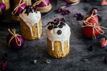 Easter cake. A traditional Orthodox dish for Easter. Easter cake with dried apricots, raisins and icing. Easter composition with painted eggs 