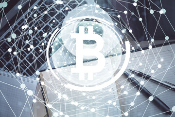 Blockchain theme hologram drawings over computer on the desktop background. Top view. Double exposure.