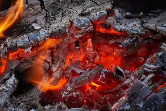 Close up view of the embers in a campfire or fireplace.