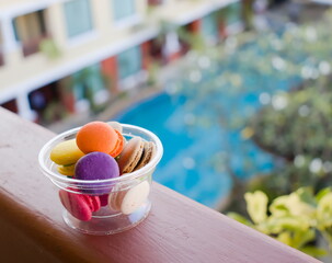 Colorful cake macaron on cup.