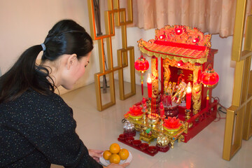 Asia woman worship spirit house.