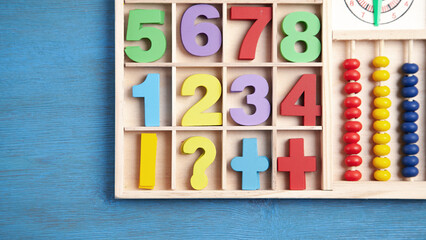 Colorful numbers on blue wooden table. Education. Learning