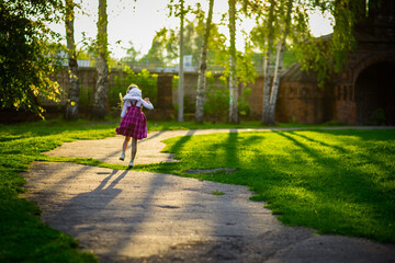 Fototapeta premium happy girl in purple dress, outdoor walks happy childhood selective focus