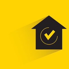 home and check mark with shadow yellow background