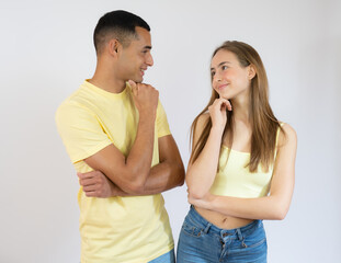 Fototapeta premium Beautiful young couple of boyfriend and girlfriend together confuse and wonder about question. Pensive concept.