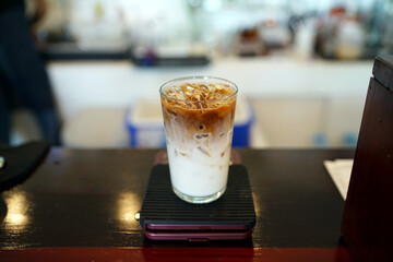 Iced Caramel Macchiato - A glass of espresso mixed with milk and vanilla syrup.
