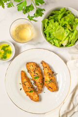 Fried filet of fish with lemon vinaigrette. White background