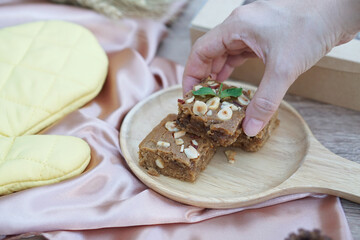 Homemade blondies brownie with nutty (almond, macadamia, cashew) on table background.