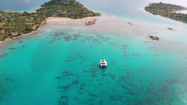 Aerial view of a catamaran yacht in the blue sea. Yachting, luxury vacation