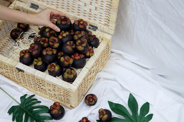 Fresh ripe mangosteen fruits on table and copy space, Thai call Queen of Fruit in Thailand.