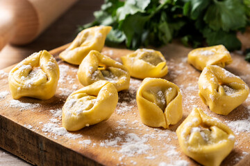 Uncooked pelmeni dumplings on rustic wooden table. typical russian food	