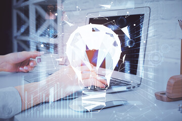 Double exposure of woman hands typing on computer and light bulb drawing. Idea concept.