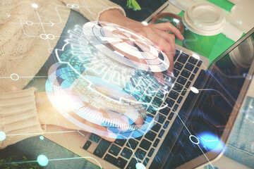 Double exposure of woman hands working on computer and data theme hologram drawing. Tech concept.