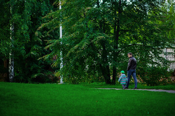 Fototapeta premium dad and son, outdoor walks happy childhood selective focus