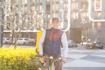 Young delivery man with yellow backpack takeaway concept