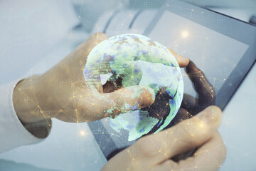 Double exposure of man's hands holding and using a phone and social network theme drawing.