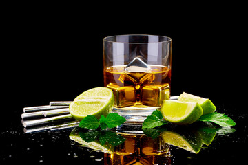 Whiskey with steel cooling cubes on dark glass background