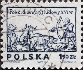 POLAND-CIRCA 1974 : A post stamp printed in Poland showing a wood carvings shows hunters with bows...