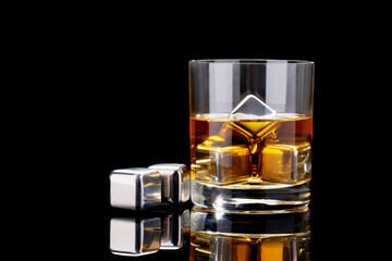 Whiskey with steel cooling cubes on dark glass background