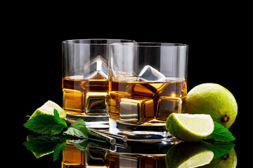 Whiskey with steel cooling cubes on dark glass background