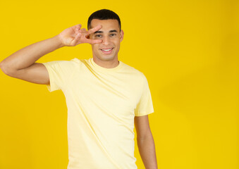 Young handsome man over isolated background smiling looking to the camera showing fingers doing victory sign. Number two.