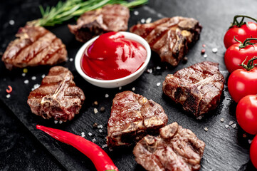 several mini Grilled beef T-bone steaks on stone background
