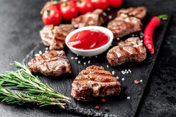 several mini Grilled beef T-bone steaks on stone background